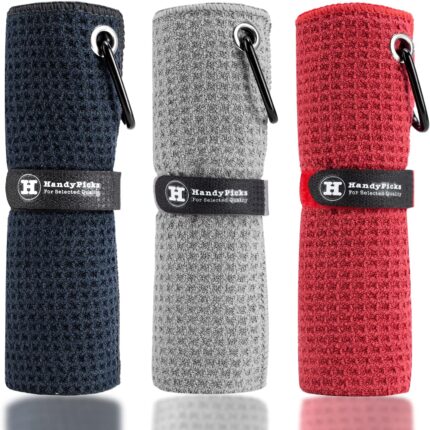 Three Handy Picks 16x16 inch microfiber golf towels in black, grey, and red, with attached carabiner clips, neatly folded.
