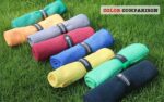 Three Handy Picks 16x16 inch microfiber golf towels in black, grey, and red, with attached carabiner clips, neatly folded.